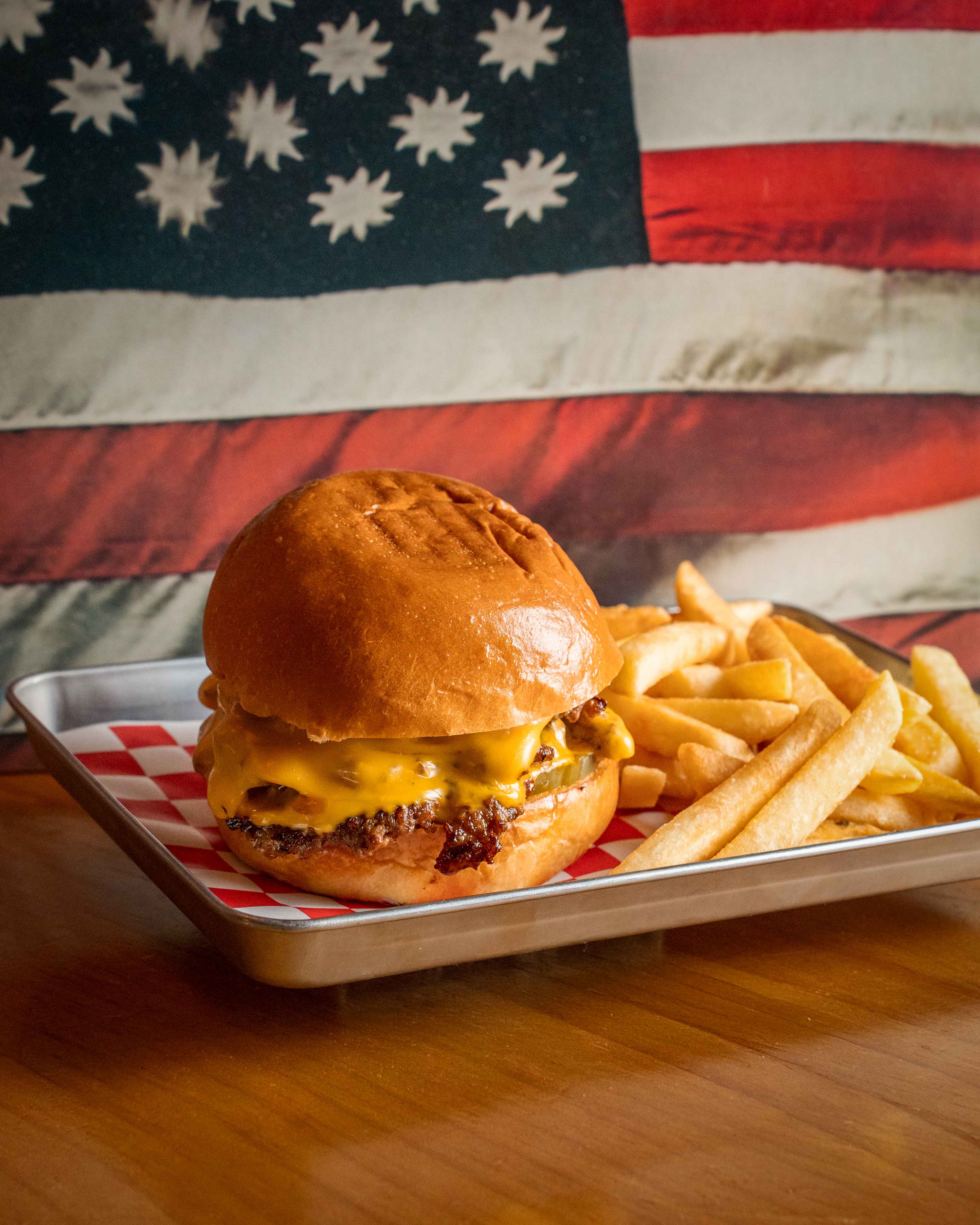 Smash burger with crispy fries - American diner classics at Graceland Hong Kong restaurant